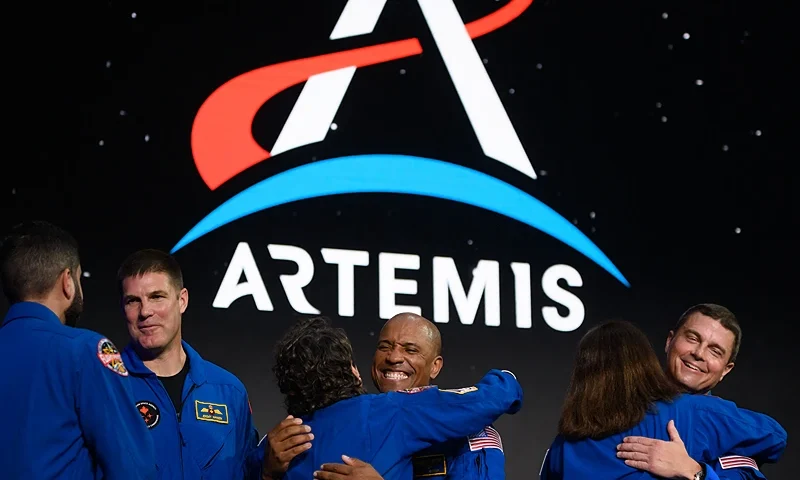 (L-R) Astronauts Jeremy Hansen, Victor Glover and Reid Wiseman hug fellow astronauts after being selected for the Artemis II mission who will venture around the Moon during a news conference held by NASA and CSA at Ellington airport in Houston, Texas, on April 3, 2023. - Traveling aboard NASAs Orion spacecraft during Artemis II, the mission is the first crewed flight test on the agencys path to establishing a long-term scientific and human presence on the lunar surface. (Photo by MARK FELIX/AFP via Getty Images)