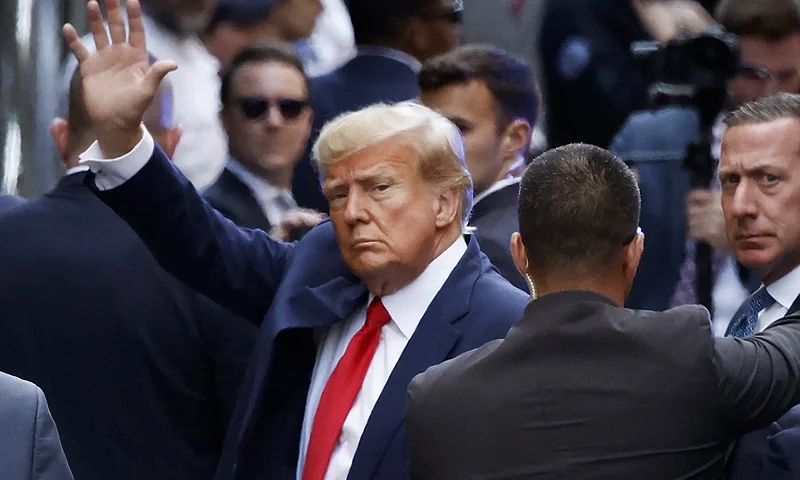 NEW YORK, NEW YORK - APRIL 04: (EDITOR'S NOTE: Alternate crop) Former U.S. President Donald Trump waves as he arrives at the Manhattan Criminal Court for his arraignment hearing on April 04, 2023 in New York, New York. Trump will be arraigned during his first court appearance today following an indictment by a grand jury that heard evidence about money paid to adult film star Stormy Daniels before the 2016 presidential election. With the indictment, Trump becomes the first former U.S. president in history to be charged with a criminal offense. (Photo by Kena Betancur/Getty Images)