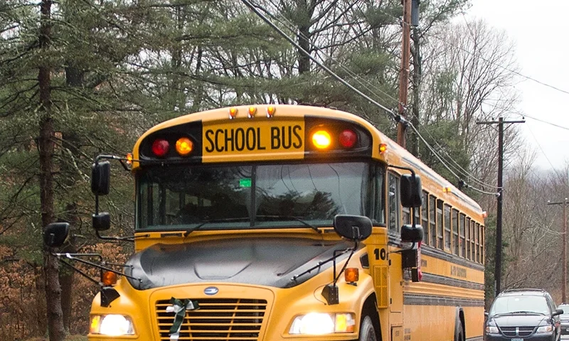 A school bus drives on December 18, 2012 in Newtown, Connecticut. Students in Newtown, excluding Sandy Hook Elementary School, return to school for the first time since last Friday's shooting at Sandy Hook which took the live of 20 students and 6 adults. AFP PHOTO/DON EMMERT (Photo by DON EMMERT/AFP via Getty Images)