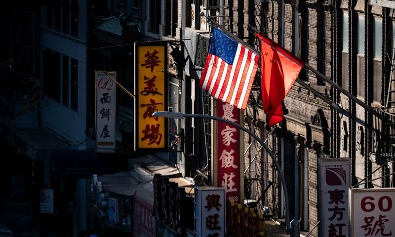 A U.S. and Chinese flag are seen in Chinatown on October 14, 2019 in New York City. (Photo by Johannes EISELE / AFP) (Photo by JOHANNES EISELE/AFP via Getty Images)