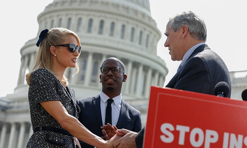 WASHINGTON, DC - APRIL 27: Actress and model Paris Hilton shakes hands with Sen. Jeff Merkley (D-OR) at a press conference outside the U.S. Capitol Building on April 27, 2023 in Washington, DC. Hilton joined lawmakers to introduce the bipartisan, bicameral bill "Stop Institutional Child Abuse Act" which would provide more oversight for institutional youth treatment programs. (Photo by Anna Moneymaker/Getty Images)