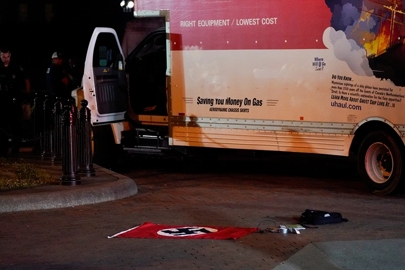 A Nazi flag and other objects recovered from a rented box truck are pictured on the ground as the U.S. Secret Service and other law enforcement agencies investigate the truck that crashed into security barriers at Lafayette Park across from the White House in Washington, U.S. May 23, 2023. REUTERS/Nathan Howard