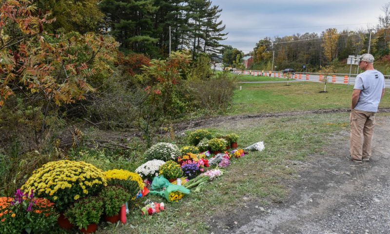 A mourner looks on at the site of the fatal limousine crash on October 8, 2018 in Schoharie, New York. 20 people died in the crash including the driver of the limo, 17 passengers, and two pedestrians. The Limousine's tracks can be seen on the other side of the flowers. (Photo by Stephanie Keith/Getty Images)