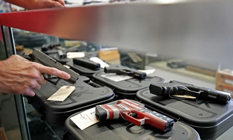 A worker restocks handguns at Davidson Defense in Orem, Utah on March 20, 2020. - Gun stores in the US are reporting a surge in sales of firearms as coronavirus fears trigger personal safety concerns. (Photo by GEORGE FREY / AFP) (Photo by GEORGE FREY/AFP via Getty Images)