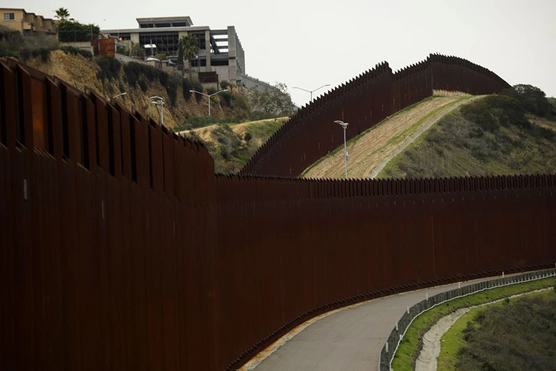 A section of the US-Mexico border wall between San Diego (R) and Tijuana (L) on January 12, 2022 in San Diego County, California. (Photo by PATRICK T. FALLON/AFP via Getty Images)