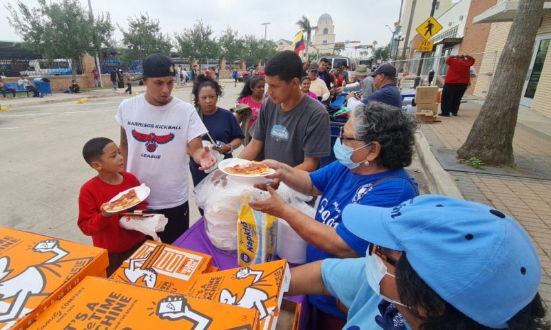 A group of Venezuelan migrants receive food and assistance from a local church in downtown Brownsville, Texas, on May 6, 2023. - Migrants crossed the Rio Grande and surrendered to Customs and Border Patrol agents a few days ago. Then they were taken to a detention center and released on American soil, where they are free to remain while a migration judge reviews their cases. Some of them are waiting for another relative to be released to continue on their way, and others are waiting for a relative that lives in the United States to buy their ticket to continue their trips. Humanitarian organizations say that there was an important increase in migrants in the last month, from 200 to 700 daily, because they are afraid that after the end of Title 42, they could be deported to their original countries or banned to enter the US for several years. (Photo by Moisés ÁVILA / AFP) (Photo by MOISES AVILA/AFP via Getty Images)