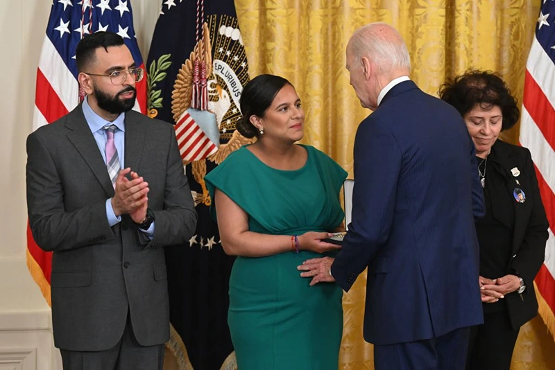 US President Joe Biden awards the Medal of Valor to (L-R) New York City Police Department (NYPD) Detective Sumit Sulan; Dominique Rivera, the wife of fallen NYPD Detective Jason Rivera; and Gabina Mora, the mother of fallen NYPD Detective Wilbert Mora, in the East Room of the White House in Washington, DC, on May 17, 2023. (Photo by SAUL LOEB / AFP) (Photo by SAUL LOEB/AFP via Getty Images)