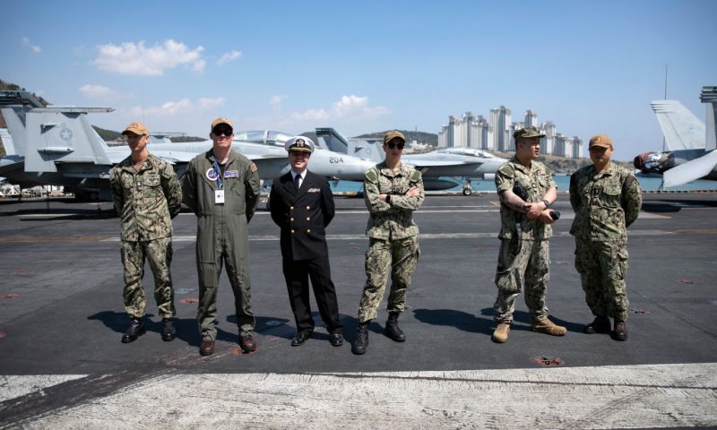 Crew members stand on patrol as U.S. Navy aircraft carrier, USS Nimitz, is anchored in Busan Naval Base on March 28, 2023 in Busan, South Korea. The nuclear-powered USS aircraft carrier Nimitz docked in Busan, 390 kilometers south of Seoul, to conduct a joint Warrior Shield exercise taking place around the Korean Peninsula. The name Warrior Shield stands for the South Korea-US Alliance's ability and resolution to solidify their combined defense posture to defend South Korea. (Photo by Woohae Cho/Getty Images)