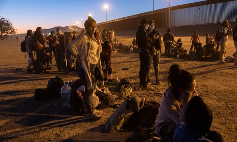 EL PASO, TEXAS - MAY 08: Immigrants seeking asylum in the United States wait near the U.S. Mexico border fence, hoping to be processed by U.S. border agents to make asylum claims on May 08, 2023 in El Paso, Texas. A surge of immigrants is expected with the end of the U.S. government's Covid-era Title 42 policy, which for the past three years has allowed for the quick expulsion of irregular migrants entering the country. (Photo by John Moore/Getty Images)