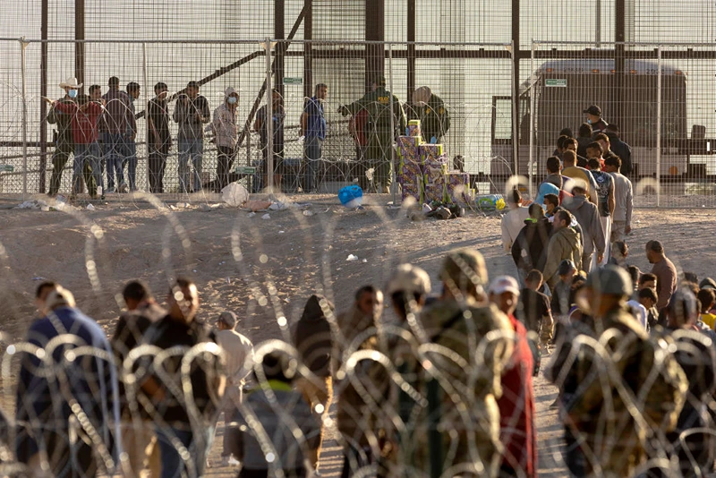 EL PASO, TEXAS - MAY 12: Immigrants wait to be transported and processed by U.S. Border Patrol agents at the U.S.-Mexico border on May 12, 2023 in El Paso, Texas. The U.S. Covid-era Title 42 immigration policy ended the night before, and migrants entering the system now are anxious over how the change may affect their asylum claims. (Photo by John Moore/Getty Images)