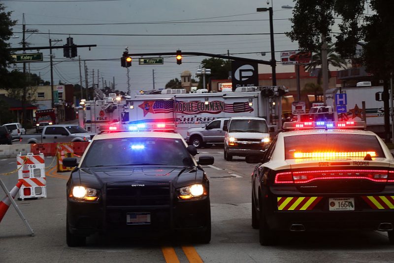 People still surround the Pulse nightclub which is still an active crime scene on June 18, 2016 in Orlando, Florida. In what is being called the worst mass shooting in American history, Omar Mir Seddique Mateen killed 49 people at the popular gay nightclub early last Sunday. Fifty-three people were wounded in the attack which authorities and community leaders are still trying to come to terms with. (Photo by Spencer Platt/Getty Images)