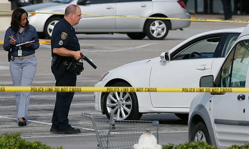 Houston Police investigators photograph a vehicle that received gunshot damage during a scene where nine people were wounded in a strip mall shooting on September 26, 2016 in Houston, Texas. The gunman was shot and killed by police officers. Three victims have been transported to Southwest Memorial Hospital, one has been taken to Ben Taub General Hospital and two have been transported to Memorial Hermann - Texas Medical Center. (Photo by Bob Levey/Getty Images)