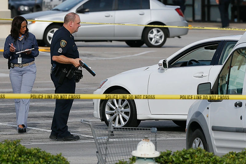 Houston Police investigators photograph a vehicle that received gunshot damage during a scene where nine people were wounded in a strip mall shooting on September 26, 2016 in Houston, Texas. The gunman was shot and killed by police officers. Three victims have been transported to Southwest Memorial Hospital, one has been taken to Ben Taub General Hospital and two have been transported to Memorial Hermann - Texas Medical Center. (Photo by Bob Levey/Getty Images)