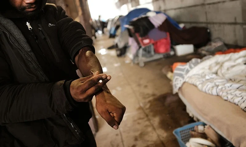 PHILADELPHIA, PA - JANUARY 24: A man uses heroin under a bridge where he lives with other addicts in the Kensington section which has become a hub for heroin use on January 24, 2018 in Philadelphia, Pennsylvania. Over 900 people died in 2016 in Philadelphia from opioid overdoses, a 30 percent increase from 2015. As the epidemic shows no signs of weakening, the number of fatalities this year is expected to surpass last year's numbers. Heroin use has doubled across the country since 2010, according to the U.S. Drug Enforcement Agency. Officials from Philadelphia recently announced that they will welcome private organizations to set up medically supervised drug injection sites as a way to combat the opioid epidemic. (Photo by Spencer Platt/Getty Images)