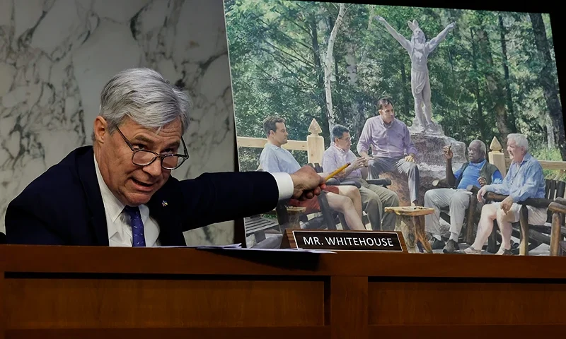 WASHINGTON, DC - MAY 02: Senate Judiciary Committee member Sen. Sheldon Whitehouse (D-RI) displays a copy of a painting featuring Supreme Court Associate Justice Clarence Thomas alongside other conservative leaders during a hearing on Supreme Court ethics reform in the Hart Senate Office Building on Capitol Hill on May 02, 2023 in Washington, DC. The painting was commissioned by billionaire Texas Republican real estate developer Harlan Crow, who, according to a recent ProPublica investigation, invited Thomas on many luxury vacations over a number of years. (Photo by Chip Somodevilla/Getty Images)
