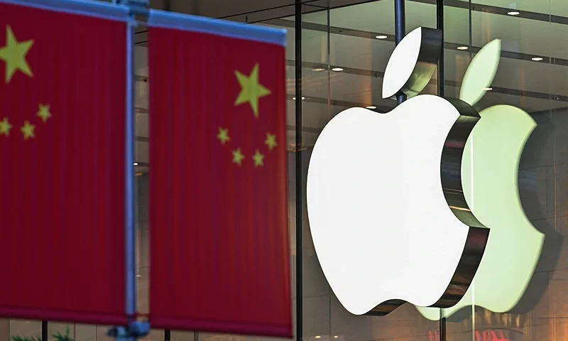 The Chinese national flag is displayed in front of an Apple store in Shanghai on October 9, 2021. (Photo by Hector RETAMAL / AFP) (Photo by HECTOR RETAMAL/AFP via Getty Images)