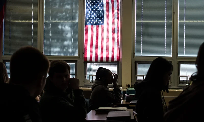 TOPSHOT - Sidney High School students sit through class under a US flag in Sidney, Ohio, October 31, 2019. - At the entrance to Sidney High School in small-town Ohio, there is a poster which reads: "Inside this building, our children are protected by an armed and trained response team." In rural Shelby County, law enforcement has trained teachers to fight back, should an attacker threaten students. They are among the first in the United States to embrace the controversial strategy. (Photo by Megan JELINGER / AFP) (Photo by MEGAN JELINGER/AFP via Getty Images)