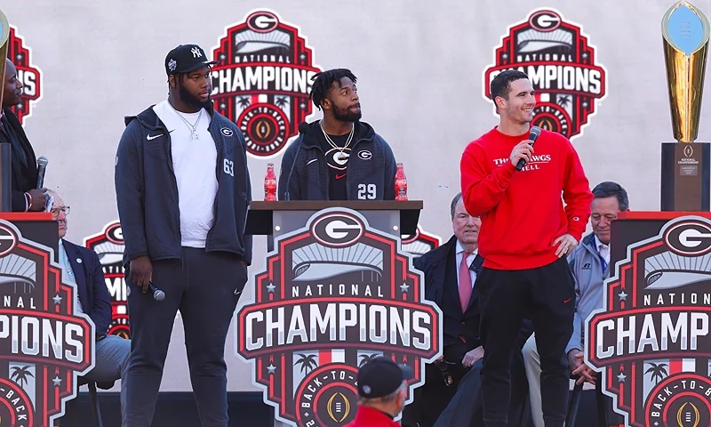 ATHENS, GA - JANUARY 14: Sedrick Van Pran #63, Christopher Smith #29 and Stetson Bennett #13 of the Georgia Bulldogs speak during the national championship celebration on January 14, 2023 in Athens, Georgia. (Photo by Todd Kirkland/Getty Images)