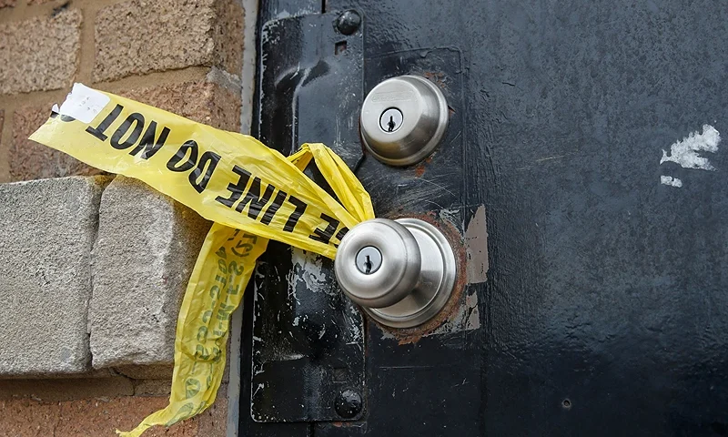 A piece of police caution tape is seen on the front door of the building where a shooting took place in Chicago, Illinois, on March 14, 2021. - At least 15 people were shot, two of them fatally, after gunfire broke out at a South Chicago business where a party was being held early on March 14, 2021. (Photo by KAMIL KRZACZYNSKI/AFP via Getty Images)
