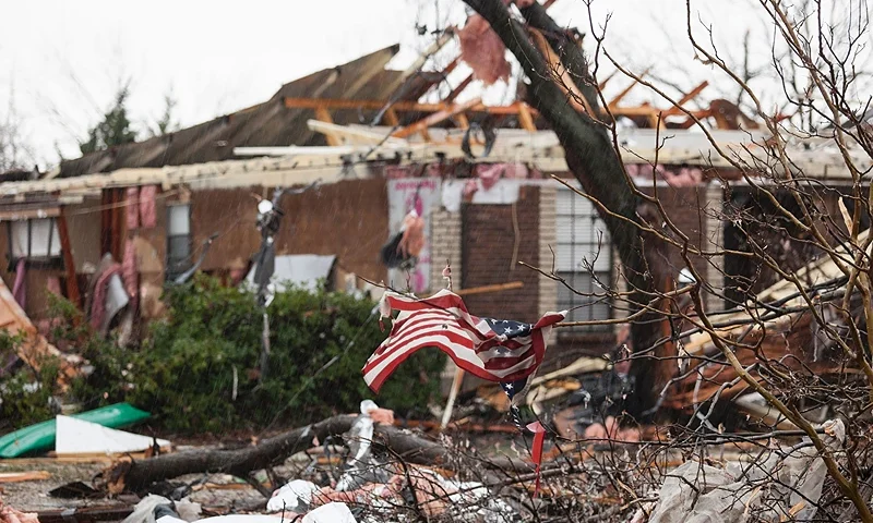An American flag placed by first responders is seen December 27, 2015 in the aftermath of a tornado in Rowlett, Texas. At least 11 people lost their lives as tornadoes tore through Texas, authorities said, as they searched home to home for possible more victims of the freak storms lashing the southern United States. The rare December twisters that flattened houses and caused chaos on highways raised the death toll from days of deadly weather across the South to at least 28. (Photo by LAURA BUCKMAN/AFP via Getty Images)