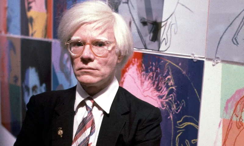 The American artist and filmmaker Andy Warhol with his paintings(1928 - 1987), December 15, 1980. (Photo by Susan Greenwood / Liaison Agency via Getty Images)