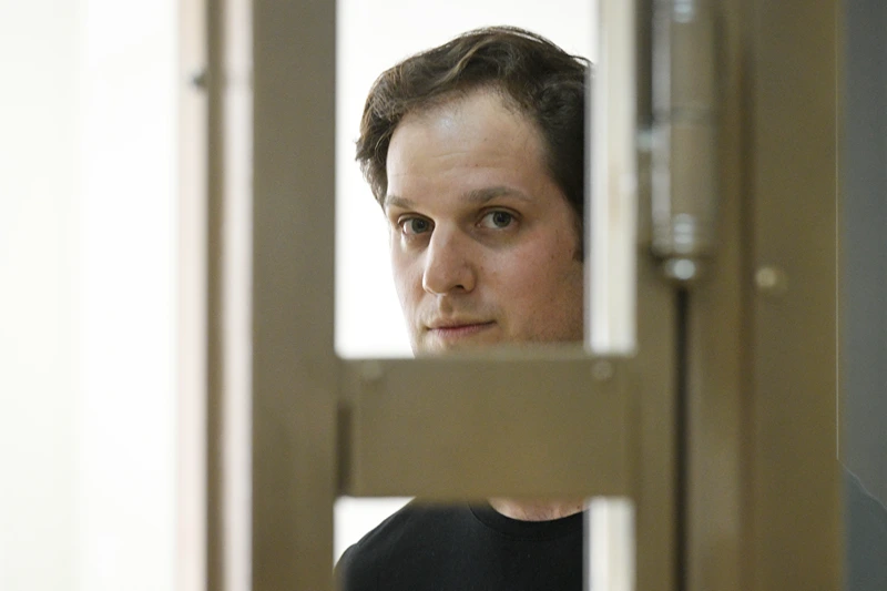 Wall Street Journal reporter Evan Gershkovich stands in a glass cage in a courtroom at the Moscow City Court in Moscow, Russia, Thursday, June 22, 2023. Gershkovich, a Wall Street Journal reporter detained on espionage charges in Russia, appeared in court Thursday to appeal his extended detention. (AP Photo/Dmitry Serebryakov)