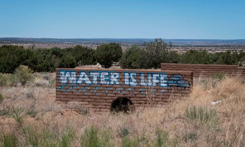 A 'Water is Life' sign is painted on a bridge near the Navajo Nation town of Steamboat, Arizona on May 24, 2020. - According to the Centers for Disease Control and Prevention, "Washing your hands is easy, and it's one of the most effective ways to prevent the spread of germs," advice it has relentlessly emphasized over the course of the coronavirus pandemic. That's just not possible for an estimated 30 to 40 percent of this sovereign territory's 178,000 residents, who don't have access to running water or sanitation. This is seen as a major reason behind the surge in COVID-19 cases in the United States' largest Native American reservation, with nearly 5,000 confirmed infections and 160 deaths at one of the highest per capita fatality rates in the country. (Photo by Mark RALSTON / AFP) (Photo by MARK RALSTON/AFP via Getty Images)