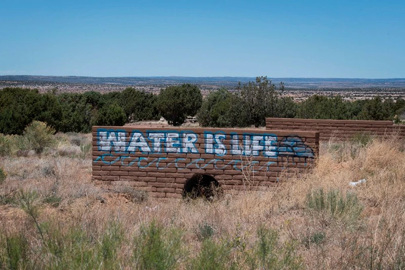 A 'Water is Life' sign is painted on a bridge near the Navajo Nation town of Steamboat, Arizona on May 24, 2020. - According to the Centers for Disease Control and Prevention, "Washing your hands is easy, and it's one of the most effective ways to prevent the spread of germs," advice it has relentlessly emphasized over the course of the coronavirus pandemic. That's just not possible for an estimated 30 to 40 percent of this sovereign territory's 178,000 residents, who don't have access to running water or sanitation. This is seen as a major reason behind the surge in COVID-19 cases in the United States' largest Native American reservation, with nearly 5,000 confirmed infections and 160 deaths at one of the highest per capita fatality rates in the country. (Photo by Mark RALSTON / AFP) (Photo by MARK RALSTON/AFP via Getty Images)