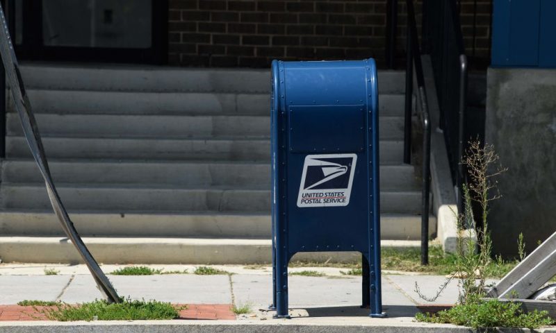 A United States Postal Service (USPS) mailbox stands in front of a post office in Washington, DC, on August 18, 2020. - The US Postal Service said on August 18 it will halt changes blamed for slowing mail delivery until after the November election, changing course in the wake of the political firestorm President Donald Trump ignited when he acknowledged he wanted to undermine the agency. (Photo by NICHOLAS KAMM / AFP) (Photo by NICHOLAS KAMM/AFP via Getty Images)