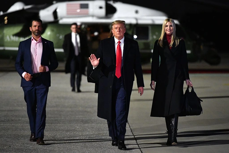 US President Donald Trump (C), daughter Senior Advisor Ivanka Trump and son Donald Trump Jr. (L) make their way to board Air Force One before departing from Dobbins Air Reserve Base in Marietta, Georgia on January 4, 2021. - President Donald Trump, still seeking ways to reverse his election defeat, and President-elect Joe Biden converge on Georgia on Monday for dueling rallies on the eve of runoff votes that will decide control of the US Senate. Trump, a day after the release of a bombshell recording in which he pressures Georgia officials to overturn his November 3 election loss in the southern state, is to hold a rally in the northwest city of Dalton in support of Republican incumbent senators Kelly Loeffler and David Perdue. (Photo by MANDEL NGAN / AFP) (Photo by MANDEL NGAN/AFP via Getty Images)