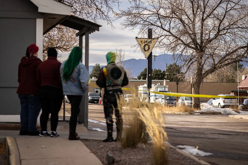 COLORADO SPRINGS, CO - NOVEMBER 23: Mourners stand outside of Club Q on November 23, 2022 in Colorado Springs, Colorado. A gunman opened fire inside the LGBTQ+ club on November 19th, killing 5 and injuring 25 others. (Photo by Chet Strange/Getty Images)