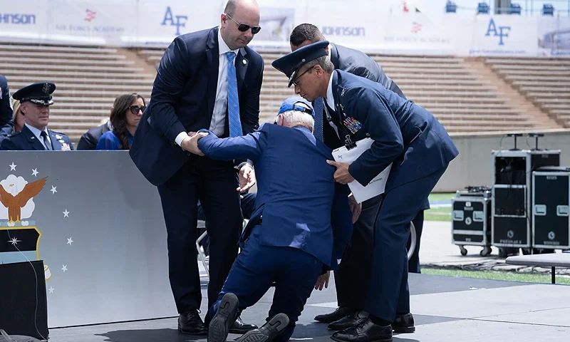 US President Joe Biden is helped up after falling during the graduation ceremony at the United States Air Force Academy, just north of Colorado Springs in El Paso County, Colorado, on June 1, 2023. (Photo by Brendan Smialowski / AFP) (Photo by BRENDAN SMIALOWSKI/AFP via Getty Images)