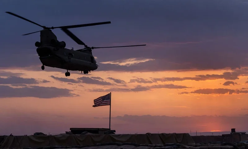 NORTHEASTERN SYRIA - MAY 25: A U.S. Army CH-47 Chinook helicopter takes off at sunset while transporting American troops out of a remote combat outpost known as RLZ on May 25, 2021 near the Turkish border in northeastern Syria. U.S. forces, part of Task Force WARCLUB operate from combat outposts in the area, coordinating with the Kurdish-led Syrian Democratic Forces (SDF) in combatting residual ISIS extremists and deterring pro-Iranian militia. U.S. troops primarily use the Oshkosh M-ATV, a Mine Resistant Ambush Protected (MRAP) vehicle. (Photo by John Moore/Getty Images)