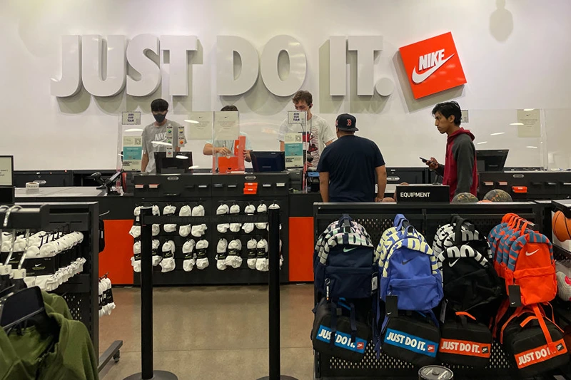 Customers make purchases at a Nike factory store on June 28, 2022 (Photo by Justin Sullivan/Getty Images)