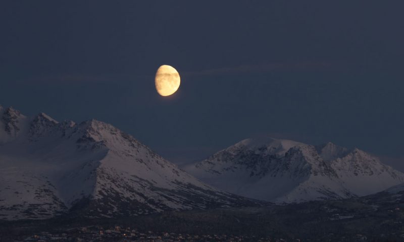 The moon rises over a mountain range at an airport where Republican U.S. Senate candidate Kelly Tshibaka meets with voters on November 03, 2022 in Anchorage, Alaska. Tshibaka is running against fellow Republican Senator Lisa Murkowski and Democrat Pat Chesbro. Early and absentee voting has begun in Alaska for the decisive midterm elections at churches, community centers, town halls an other locations until Election Day on November 8th. In one of the most closely watched contests in the state, Democrat Mary Peltola, the first Native Alaskan to be elected to the House of Representatives, is running against three candidates including Sarah Palin. (Photo by Spencer Platt/Getty Images)