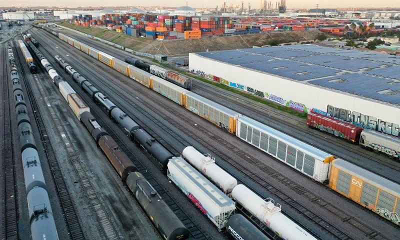 WILMINGTON, CALIFORNIA - NOVEMBER 22: In an aerial view, freight rail cars sit in a rail yard near shipping containers on November 22, 2022 in Wilmington, California. A national rail strike could occur as soon as December 5 after the nation’s largest freight rail union, SMART Transportation Division, voted to reject the Biden administration’s contract deal. About 30 percent of the nation’s freight is moved by rail with the Association of American Railroads estimating that a nationwide shutdown could cause $2 billion a day in economic losses. (Photo by Mario Tama/Getty Images)