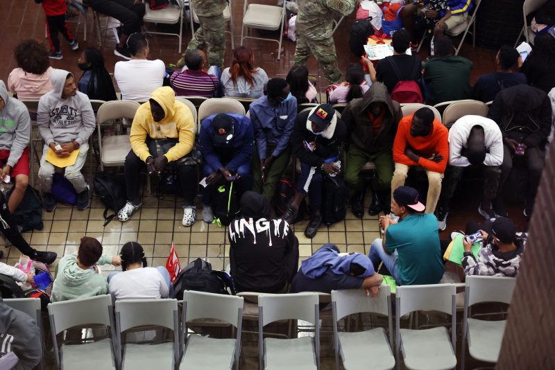 NEW YORK, NEW YORK - MAY 15: Newly arrived asylum seekers wait in a holding area at the Port Authority bus terminal before being sent off to area shelters and hotels on May 15, 2023 in New York City. The historic Roosevelt Hotel in midtown is being prepped to reopen shortly to accommodate an anticipated influx of asylum seekers into New York City. With migrants arriving weekly on buses from Texas and other parts of the country, Mayor Eric Adams' administration is under pressure to find shelter for the thousands of individuals and families looking to start new lives in America. Mayor Adams announced Saturday that the city will utilize the closed hotel to eventually provide as many as 1,000 rooms for migrants. (Photo by Spencer Platt/Getty Images)