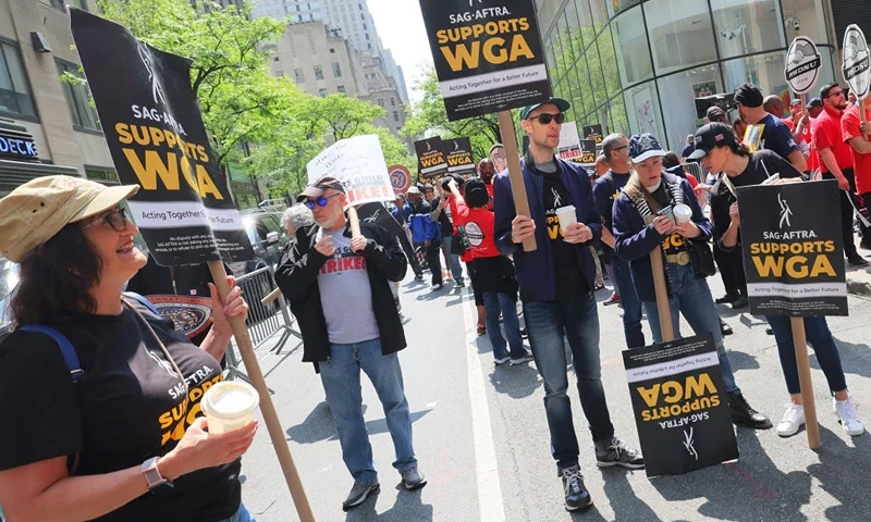 Writers Guild of America (WGA) East members participate in a “Rally at the Rock” strike event outside of the NBCUniversal offices on May 23, 2023 in New York City. (Photo by Michael M. Santiago/Getty Images)