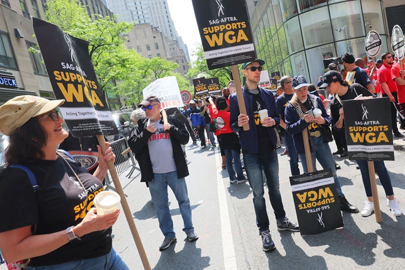Writers Guild of America (WGA) East members participate in a “Rally at the Rock” strike event outside of the NBCUniversal offices on May 23, 2023 in New York City. (Photo by Michael M. Santiago/Getty Images)