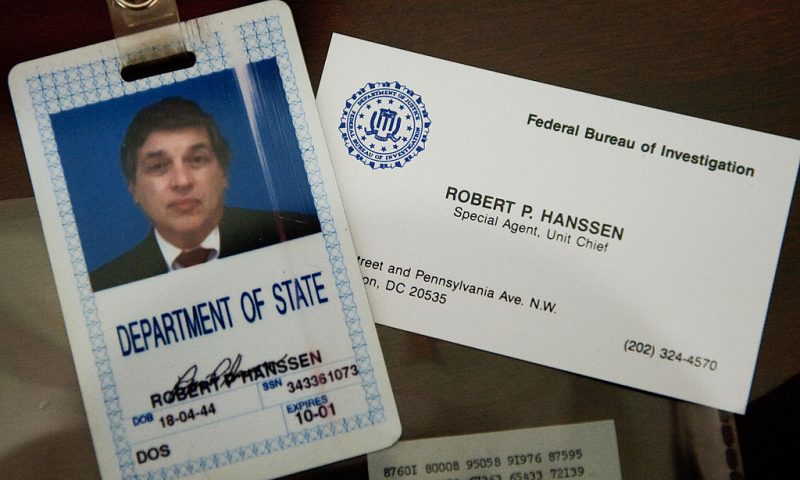 The identification and business card of former FBI agent Robert Hanssen are seen inside a display case at the FBI Academy in Quantico, Virginia, May 12, 2009. Hanssen was sentenced to life in prison without parole for spying for the Soviet Union and Russia while he worked for the FBI. AFP Photo/Paul J. Richards (Photo credit should read PAUL J. RICHARDS/AFP via Getty Images)