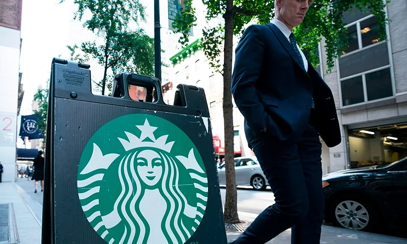 A man walks past a sign on the sidewalk for Starbucks May 29, 2018 in New York. - Starbucks closed more than 8,000 stores across the US Tuesday to conduct employee training on racial bias, a closely watched exercise that spotlights lingering problems of discrimination nationwide. (Photo by Don EMMERT / AFP) (Photo credit should read DON EMMERT/AFP via Getty Images)
