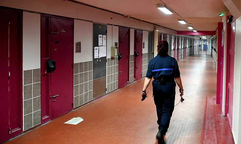 A prison guard walks in a corridor past of the Grenoble-Varces prison, on July 4, 2018 in Varces-Allieres-et-Risset. - The project carried by the 'La Belle Electrique' and the Isere penitentiary service of insertion and probation allow prisoners to become musical programmers. (Photo by JEAN-PIERRE CLATOT / AFP) (Photo by JEAN-PIERRE CLATOT/AFP via Getty Images)