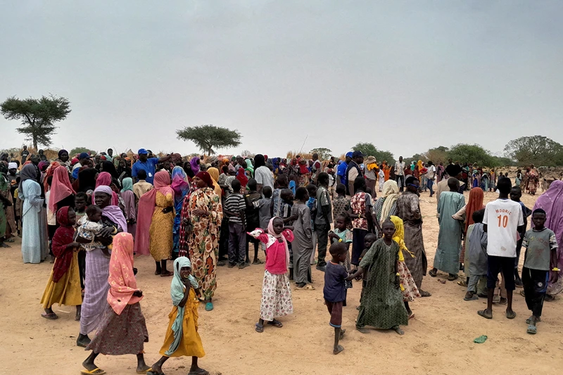 Sudanese people, who fled the violence in their country and newly arrived, wait to be registered at the camp near the border between Sudan and Chad in Adre, Chad April 26, 2023. REUTERS/Mahamat Ramadane/File Photo