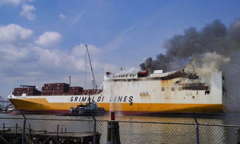 Emergency personnel battle against a fire aboard the Italian-flagged Grande Costa d'Avorio cargo ship at the Port of Newark, Friday, July 7, 2023, in Newark, N.J. The cargo ship burned for a third day Friday at the port after a fire that claimed the lives of two Newark firefighters Augusto "Augie" Acabou and Wayne "Bear" Brooks Jr. , and exposed gaps in the ability of fire crews to respond to emergencies on hulking container ships. (AP Photo/John Minchillo)