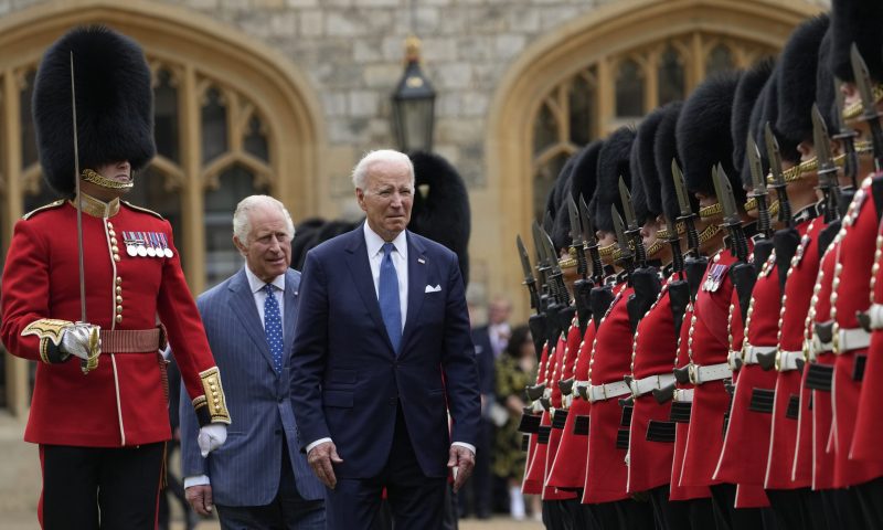 US President Joe Biden reviews royal guards along with Britain's King Charles III during a welcoming ceremony at Windsor Castle in Windsor, England, Monday, July 10, 2023. (AP Photo/Susan Walsh)