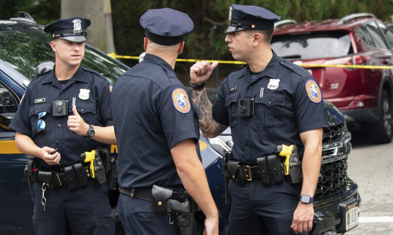 Police officers stand guard near the house where a suspect has been taken into custody on New York's Long Island in connection with a long-unsolved string of killings, known as the Gilgo Beach murders, Friday, July 14, 2023, in Massapequa Park, N.Y. (AP Photo/Eduardo Munoz Alvarez)