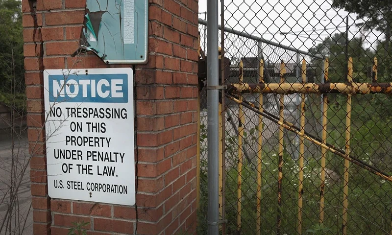 GARY, INDIANA - JUNE 20: A sign warning against trespassing is posted on a fence that surrounds the United States Steel's (USS) Gary Works facility on June 20, 2019 in Gary, Indiana. USS recently announced that it would temporarily shut down a blast furnace at the facility, another at a USS facility near Detroit and idle a third plant in Europe. The moves come as falling steel prices and weakening demand threaten the industry. Less than one year ago President Donald Trump visited a USS facility in Granite City, Illinois as it was being brought back online and credited his tariffs on steel imported from China for creating the favorable conditions for the U.S. steel industry. (Photo by Scott Olson/Getty Images)
