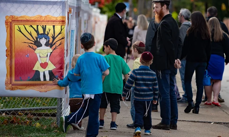 PITTSBURGH, PA - OCTOBER 27: Visitors look at inspired artworks along the fence at the Tree of Life Synagogue on the 1st Anniversary of the attack on October 27, 2019 in Pittsburgh, Pennsylvania. One year ago, Robert Bowers killed 11 people and wounded severa others during an attack of the Tree of Life synagogue. (Photo by Jeff Swensen/Getty Images)