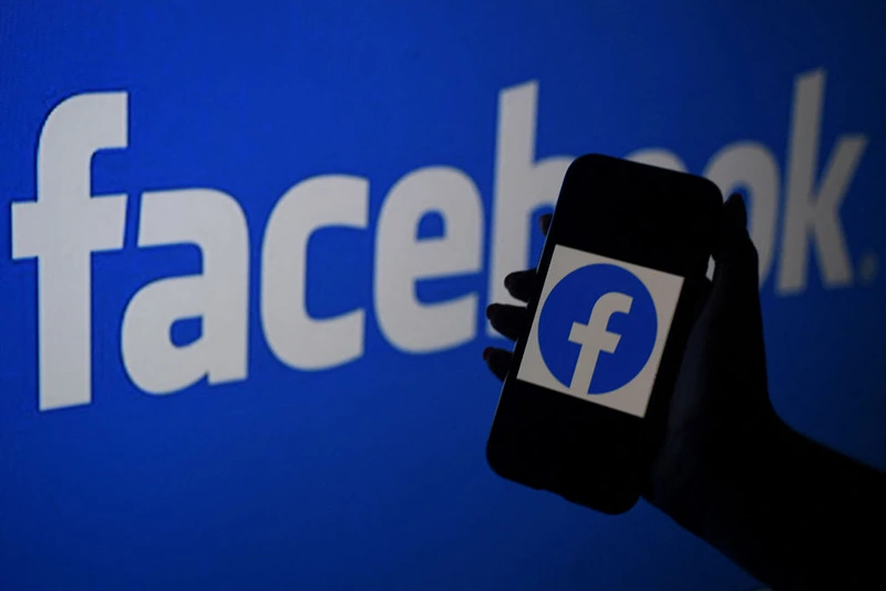 In this photo illustration, a smart phone screen displays the logo of Facebook on a Facebook website background, on April 7, 2021, in Arlington, Virginia - Facebook usage has held steady in the United States despite a string of controversies about the leading social network, even as younger users tap into rival platforms such as TikTok, a survey showed Wednesday. (Photo by OLIVIER DOULIERY / AFP) (Photo by OLIVIER DOULIERY/AFP via Getty Images)