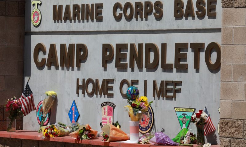 Flowers and other keepsakes adorn the entrance sign to Camp Pendleton on August 27, 2021 in Oceanside, California. 170 people were killed, including 13 U.S. Servicemen during an ISIS-led terrorist attack outside of the Kabul Airport. (Photo by Sandy Huffaker/Getty Images)